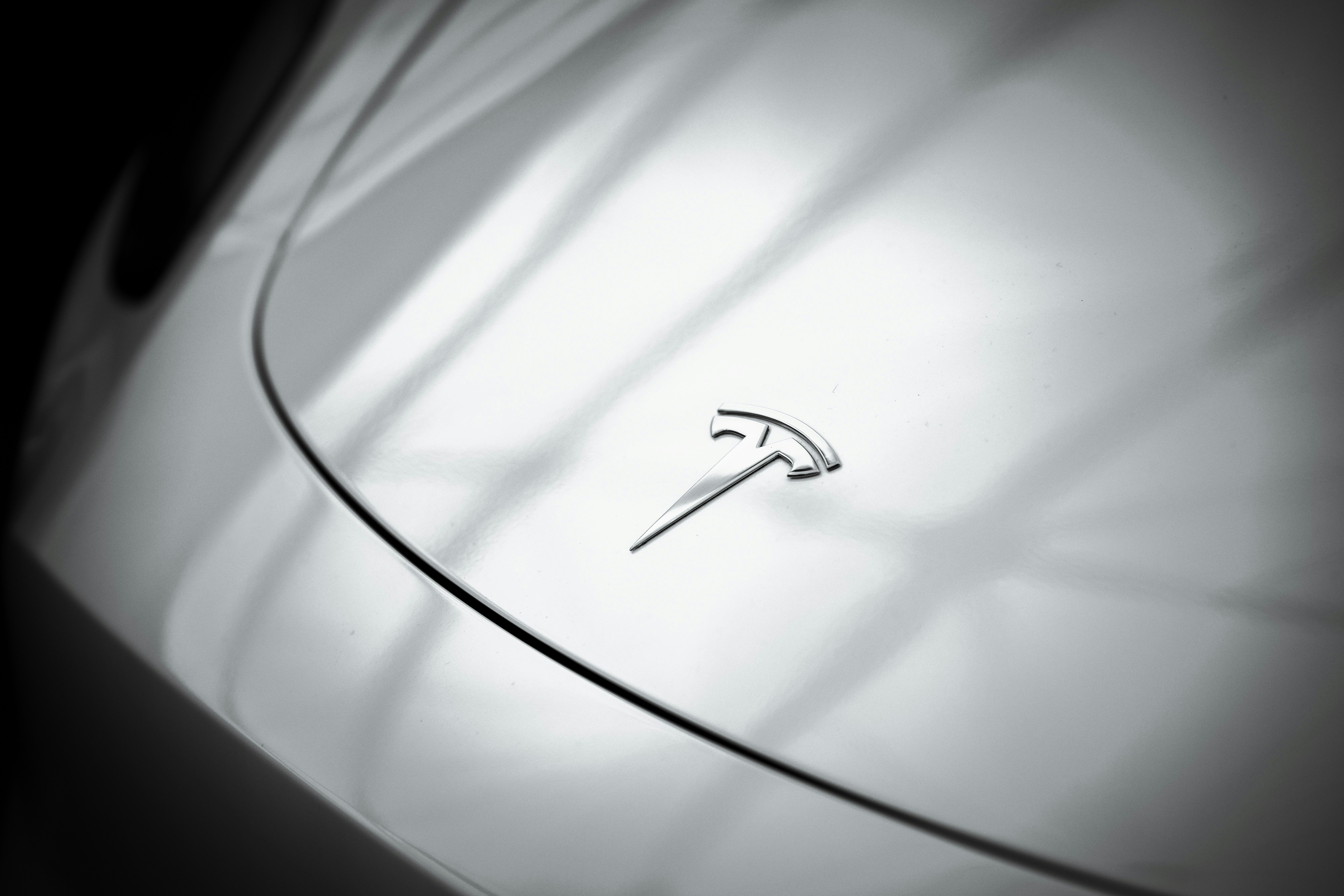 Tesla logo detail on electric vehicle surface